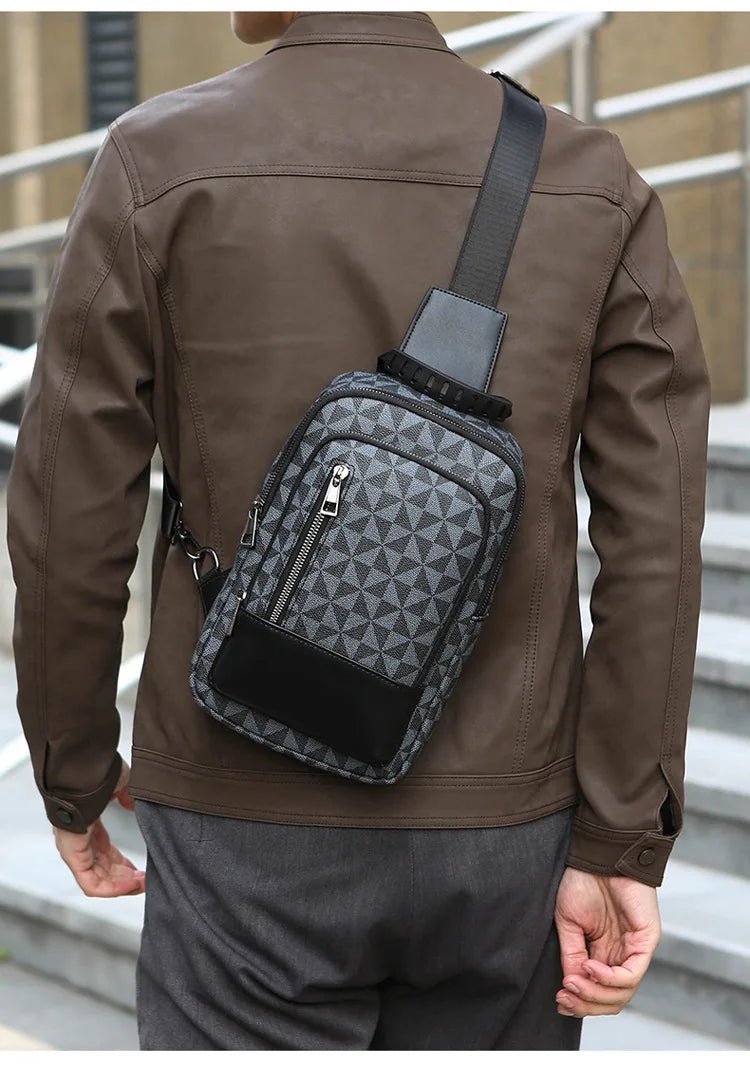 A man wearing a brown leather jacket holds a black geometric pattern crossbody bag.