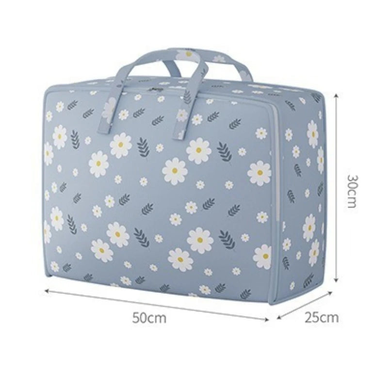 Light blue fabric storage bag with a floral pattern, designed for storing blankets and clothes.