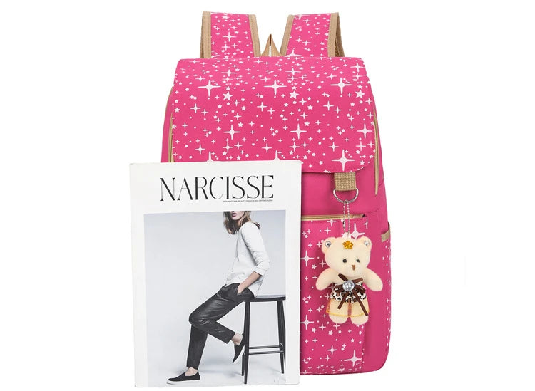 A pink star-patterned backpack featuring a white frame with the name Narcisse and a teddy bear charm.