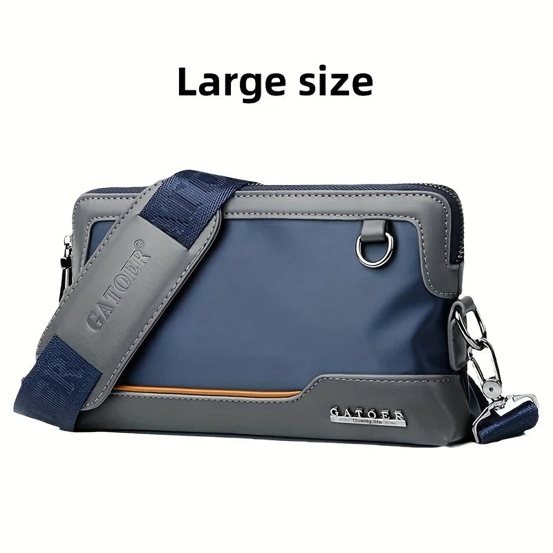 A large gray and blue crossbody bag with a padded strap and silver hardware.