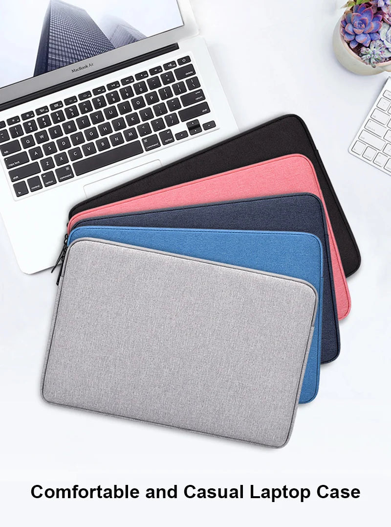 A stack of colorful laptop sleeves and a silver laptop are displayed on a white surface.