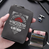 A dark gray compact card wallet with the text The Family Business Winchester Saving People and Hunting Things is shown being 