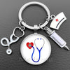 Silver keychain featuring a stethoscope charm and a medical cross emblem.