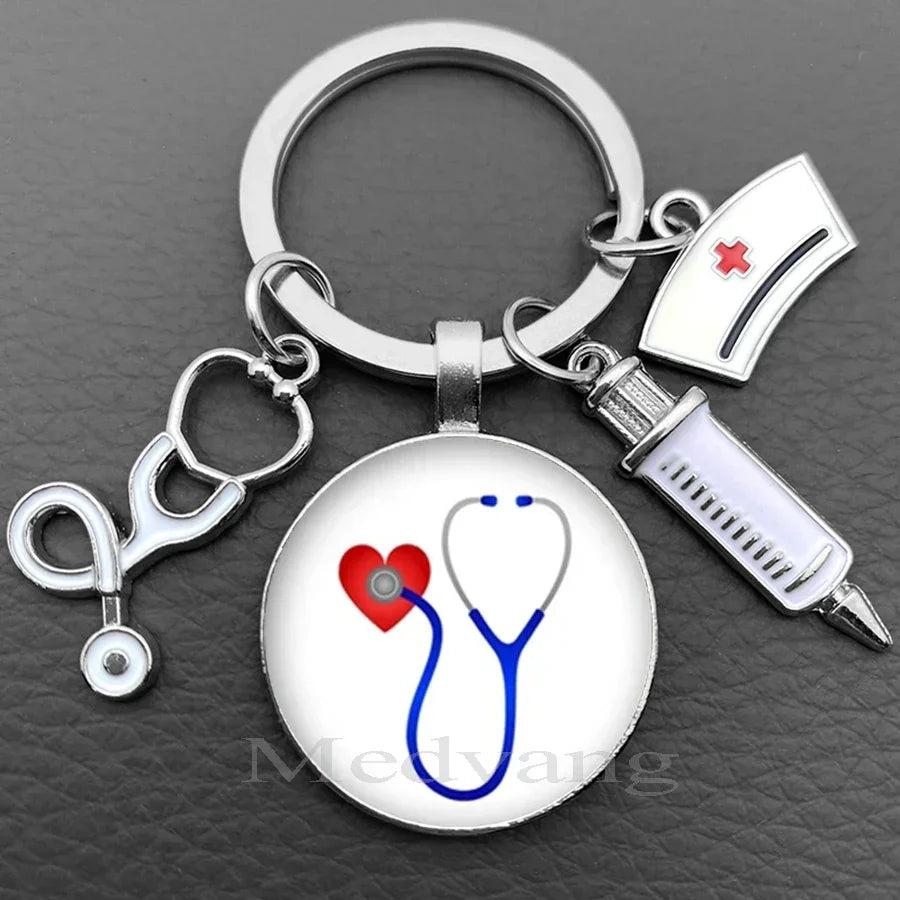Silver keychain featuring a stethoscope charm and a medical cross emblem.