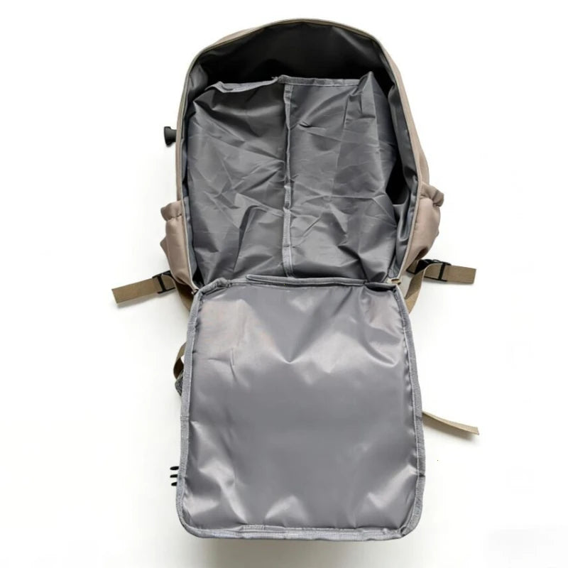 A gray compact travel backpack is shown open, displaying its interior storage and organization.
