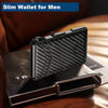 A black textured slim wallet for men resting on a dark leather card holder.