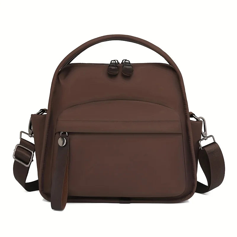 A brown chic multi-pocket shoulder crossbody bag with leather straps and a top handle.