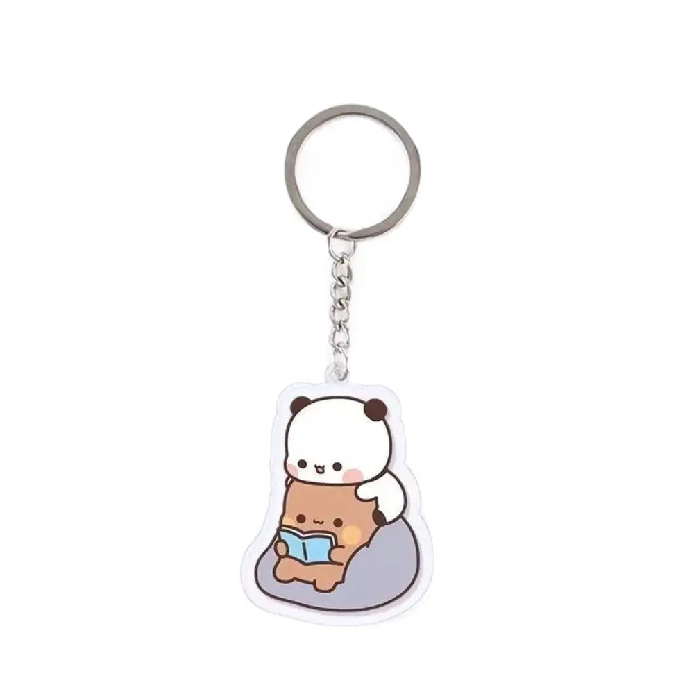A clear plastic keychain charm featuring a cute cartoon bear character.
