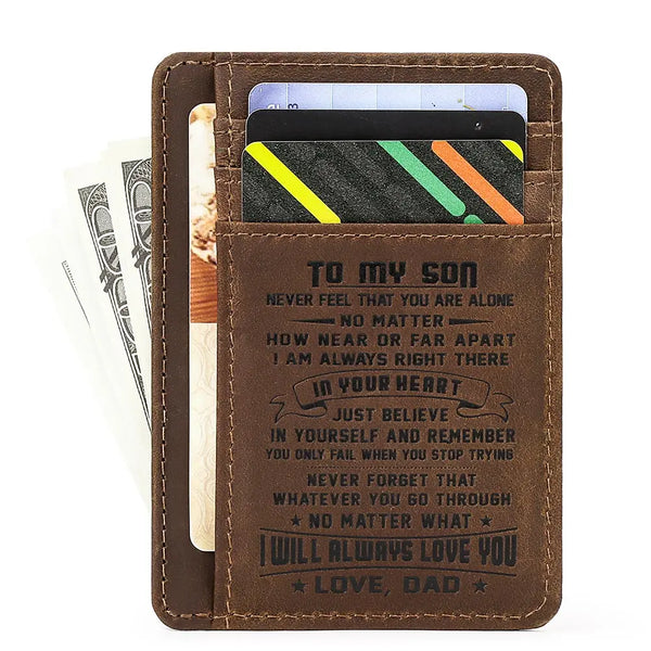 A brown leather card wallet with a personalized message engraved on the cover and displaying credit cards.