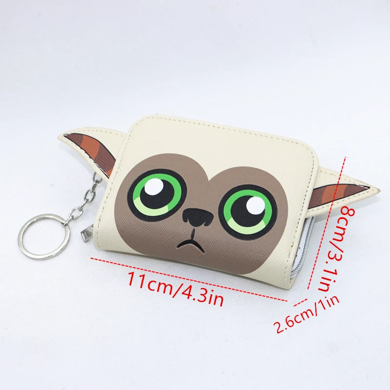 A beige loungefly zipper wallet shaped like a cartoon animal with large green eyes and brown ears.