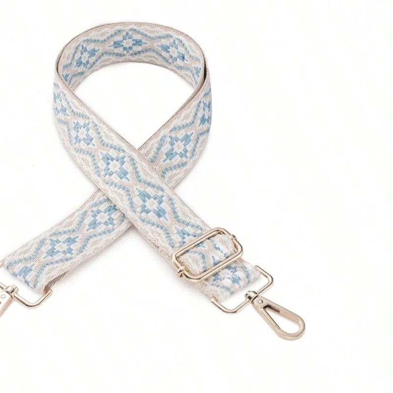 A light blue and white patterned replacement bag strap with silver hardware.