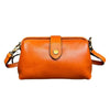 An orange genuine leather crossbody bag with a brass buckle closure.