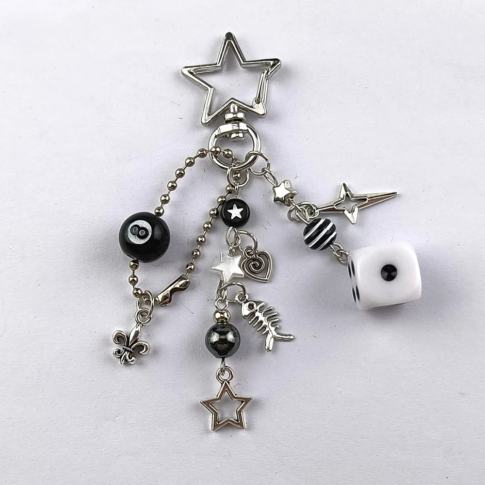 Silver Y2K 8 Ball keychain charm featuring a star and various charms for keys and bags