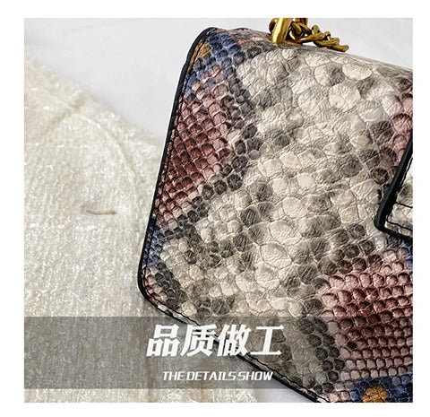 A close-up of an elegant retro crocodile print crossbody bag with gold hardware.