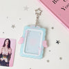 A clear acrylic photo card holder featuring a light blue frame with pink accents and angel wings, suspended by a silver charm