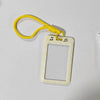 A yellow polka dot card holder with a matching yellow lanyard is displayed on a white surface.