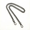 A silver metal chain crossbody strap laid out on a white background.