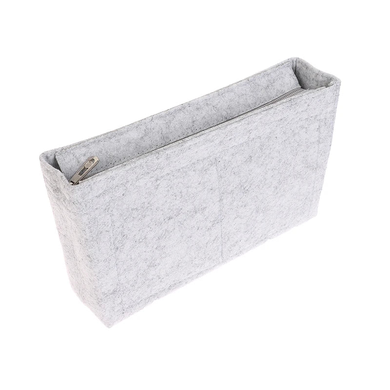 A light gray felt cosmetic bag insert organizer with a zippered opening.