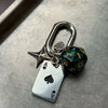 Silver keychain featuring a die shaped charm and an Ace of Spades pendant
