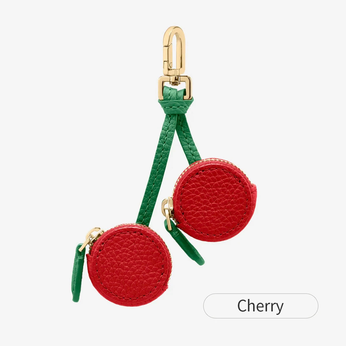 A red coin purse keychain with a gold clasp and green cord.