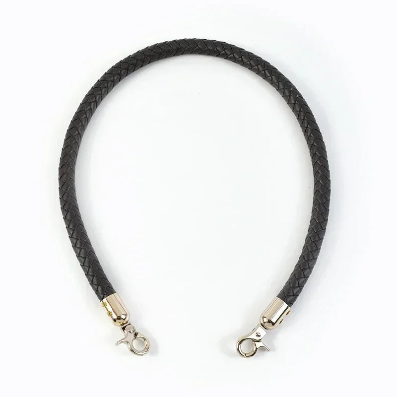 Black braided leather bag handles with gold-toned metal buckles