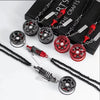 A set of black and red alloy wheel hub brake disc rearview mirror pendants displayed on a black box.