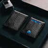 A black slim RFID-blocking front pocket wallet is shown resting on a dark surface next to an RFID protection device.