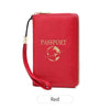 A red passport holder wallet with a wrist strap and gold accents.