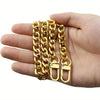 A hand holds several gold-colored metal chain straps for bags and wallets.