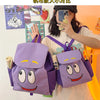 A person is holding a purple Dora The Explorer cartoon flannel backpack and a smartphone.
