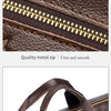 Close-up of a brown leather laptop briefcase showing a gold metal zipper and leather handle.