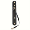 A black vintage leather glove holder strap with brass hardware.