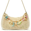 A beige straw shoulder bag adorned with colorful sea star and shell charms.