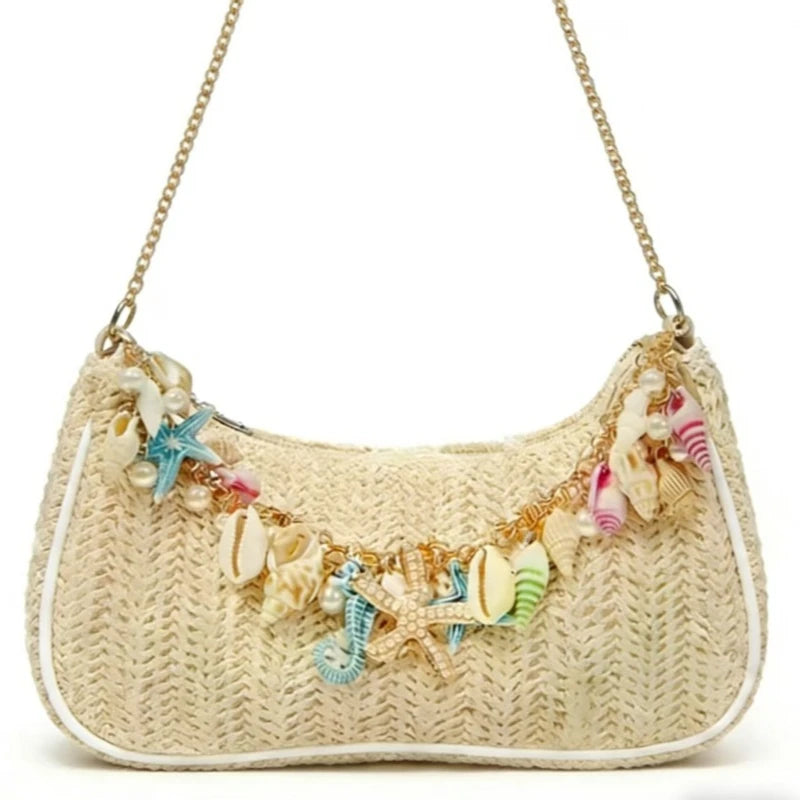 A beige straw shoulder bag adorned with colorful sea star and shell charms.