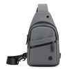 A gray lightweight nylon crossbody sling bag with a black strap and zippered compartments.