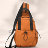 An orange casual backpack with black straps and a laptop compartment shown from the back.