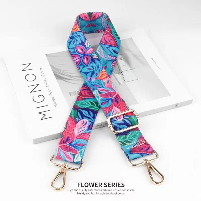 Colorful nylon bag strap featuring a floral pattern used as a crossbody or shoulder replacement