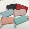A collection of elegant PU leather coin purses and card holders in black, red, pink, and mint green colors arranged on a whit