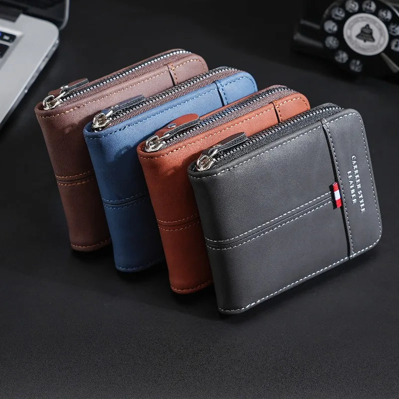 Four leather wallets in shades of brown, blue, and gray are displayed on a dark surface.