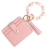 A pink silicone bead and leather card wallet with a white and pink beaded bracelet.
