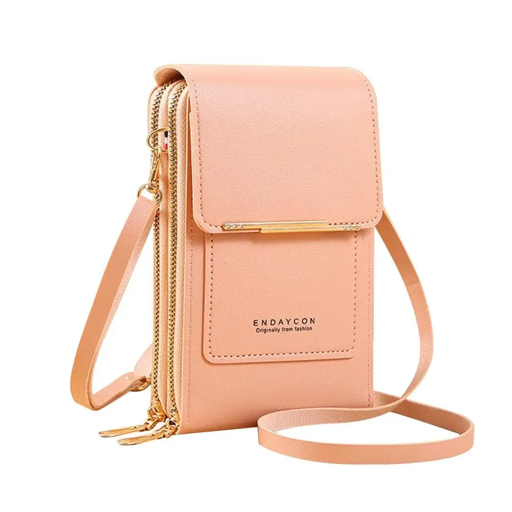 A light peach colored RFID-protected touch screen crossbody bag with gold hardware and a zipper.