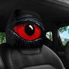 A close-up of a car headrest cover featuring a stylized red and black eye design.
