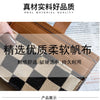 A close-up of a tan and black checkered PU leather mini card wallet with a brown leather strap.
