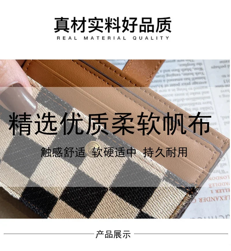 A close-up of a tan and black checkered PU leather mini card wallet with a brown leather strap.