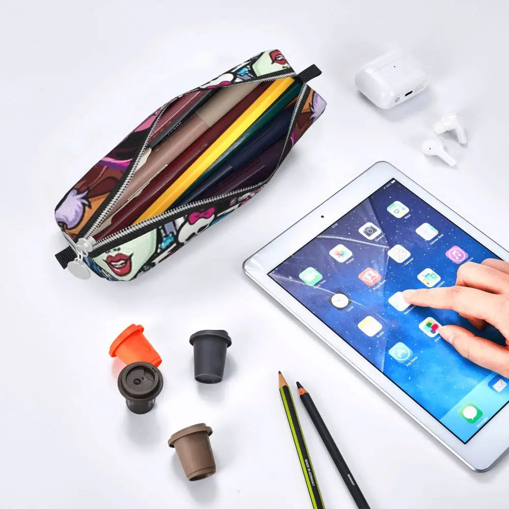 An elegant leather pencil case is shown open next to a tablet and various writing tools on a white background.