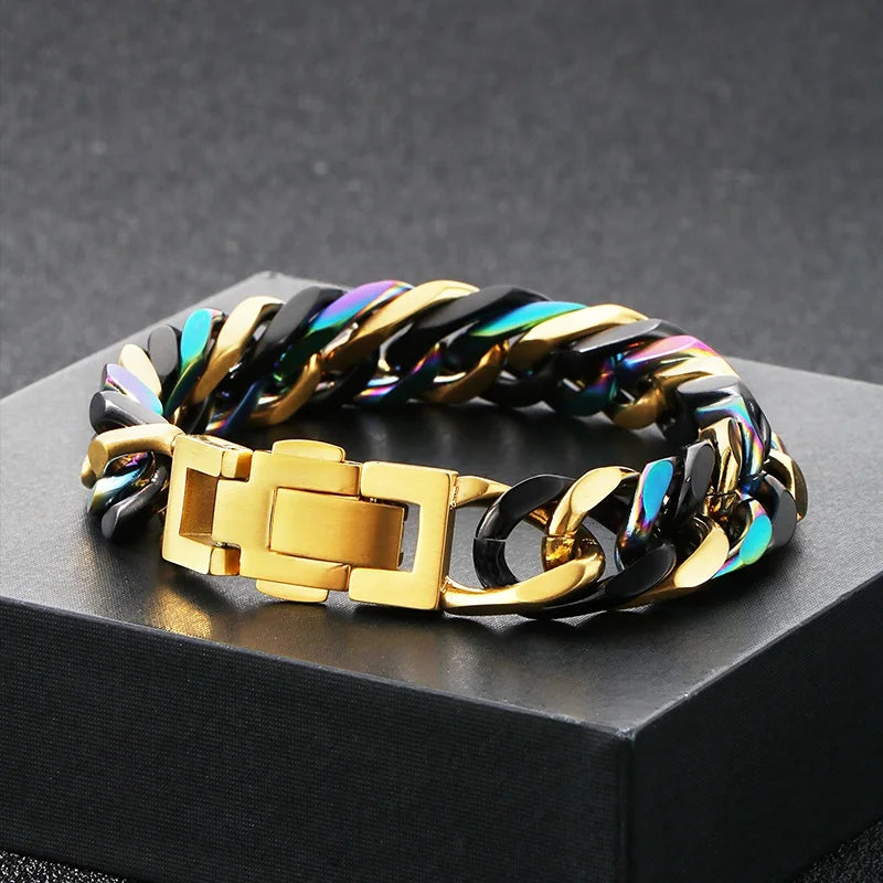 A chunky gold and black Cuban link bracelet with iridescent blue and purple accents displayed on a dark surface.