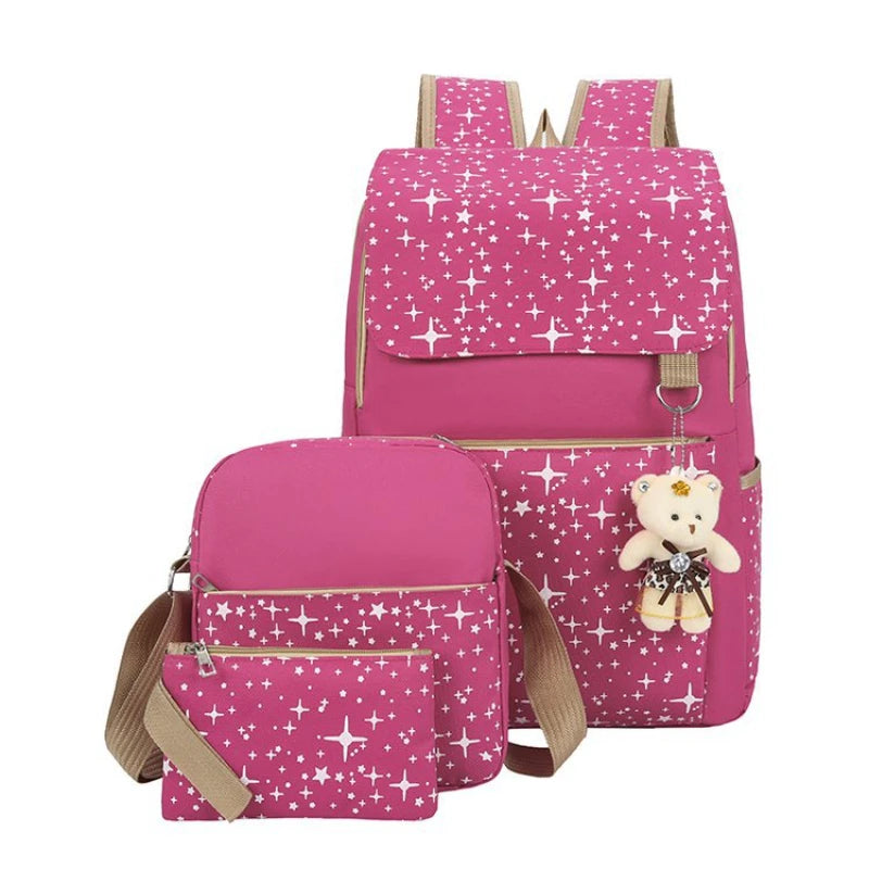 A pink durable canvas student backpack with a pattern of white stars and a teddy bear charm.