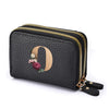 Black faux leather mini wallet with a gold zipper and a rose floral letter print