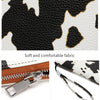 Detail display of a black and white cow print PU leather fabric, smooth zipper, and a comfortable hand strap.