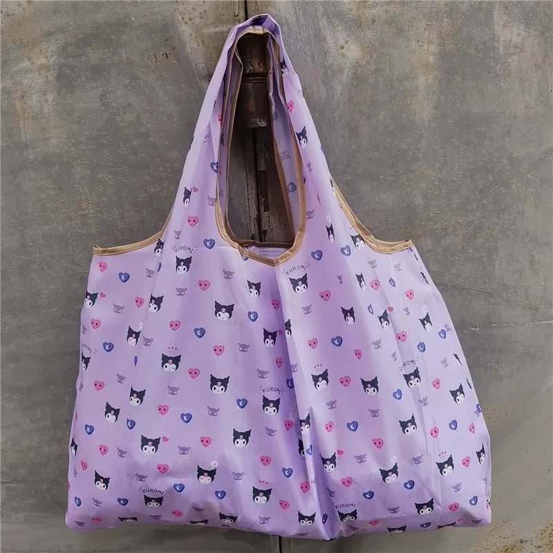 A purple reusable shopping bag featuring a pattern of small black cats on a light background.